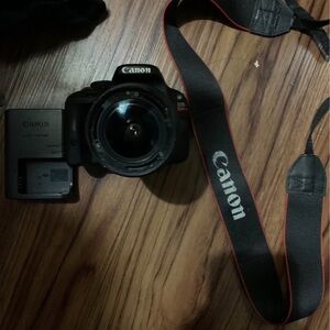 Canon Black DSLR Camera with Red-Accented Strap